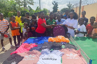 Rhoda (in white) making the presentation to the Asoba Table Tennis Foundation