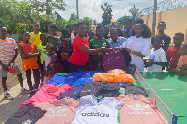 Rhoda (in white) making the presentation to the Asoba Table Tennis Foundation