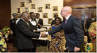 President Akufo-Addo in a handshake with one of the Ambassadors