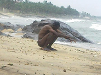 File photo: Man defecates in the open at the beach