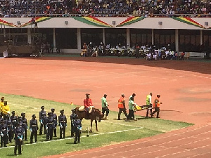 A personnel from the prison's service being carried off by First Aid officers