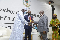 Moussa Faki Mahamat receiving the keys to the AfCFTA Secretariat Building from Akufo-Addo