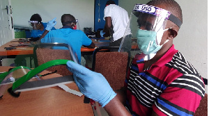 Workers prepare face shields from recycled plastics in Dar es Salaam