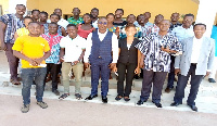 The DCE, Daniel Kwame Gariba with some of the beneficiaries in a group picture