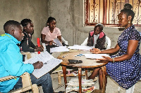 A primary school teacher (right) conducts a lesson in Kagote Village, Fort Portal City