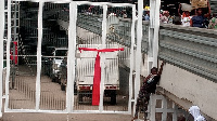 A red band tied around a gate