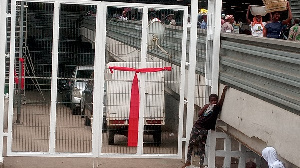 A red band tied around a gate