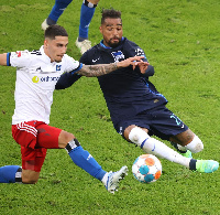 KP Boateng (right) puts in a sliding tackle