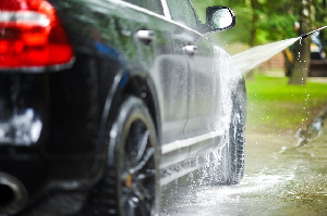 Water polluted with soap and chemicals is discharged into the environment from washing bays