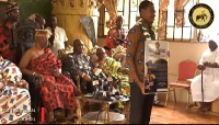 Nathan Codjoe displying his award at the Ga Mantse palace