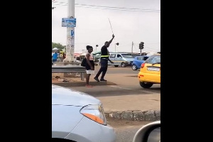 The MTTD officer using a cane to redirect disobedient pedestrians