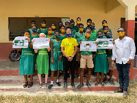 Mrs Amelor in picture with students of Sohume Basic School after the donation