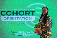 A Cohort 6 entrepreneur holding her plant at the orientation event