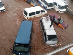 People battling for their lives and properties in a flooded scene