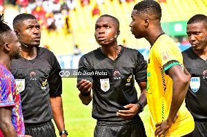 Referee Rustum Senorgbe (middle)