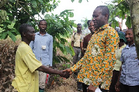 Joseph Boahen Aidoo exchanging pleasantries with a farmer