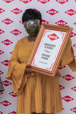 Orkin Ghana CEO Cecilia Agadzi with plaque