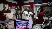 People pray and sing during a worship radio show at Accra FM station in Accra on April 26, 2021