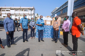 Former President John Mahama and some members of the NDC's COVID-19 Response team making a donation