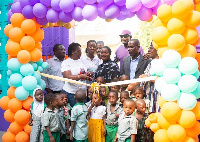 Hollard Ghana cutting ribbon for the opening of Al-Waleed Kindergarten at Nima