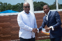 Kenpong in a handshake with John Mahama