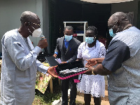 Ms Kendall Ficken (second left) handing over the instruments