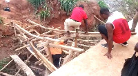 Some residents crossing the unfinished bridge