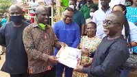 Nyamekye-Marfo (left) making the presentation to Dr Amponsah (right)