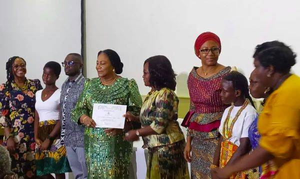 Rebecca Akufo-Addo receiving a citation from the Childhood Cancer Society of Ghana