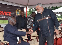 Former presidents Kufuor and Rawlings in a hearty handshake