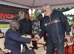 Former presidents Kufuor and Rawlings in a hearty handshake