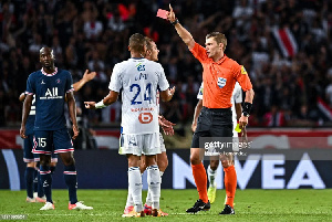 Willy Delajod shows a red card to Alexander Djiku [Photo by Baptiste Fernandez/Icon Sport via Getty]