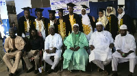 Graduates in a photograph with school's director (3rd right) and other staff members