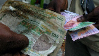 People exchange money in Abidjan. REUTERS/Thierry Gouegnon