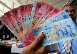 One and five Ghana cedis notes.        File photo.