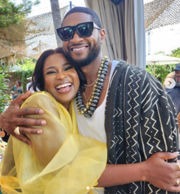 Berla Mundi hugs Usher