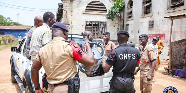 Officials with some of the arrested suspects