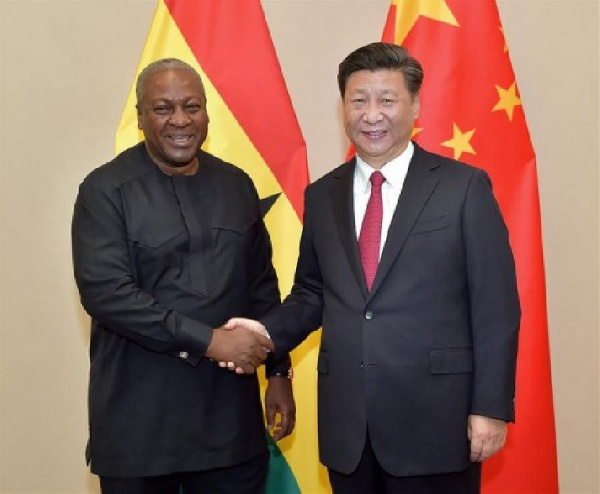 President Mahama in a handshake with President Xi