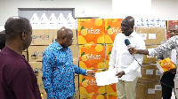 Kwaku Agyemang-Manu receiving the medical supplies from Tobinco