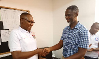 Dr. Clement Abas Apaak presenting the donation to the head of the dialysis centre