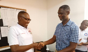 Dr. Clement Abas Apaak presenting the donation to the head of the dialysis centre