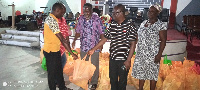 Local management of the church presenting the items to one of the beneficiaries