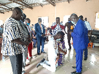 Pastors of the Church praying for the new Pastor and his wife on their knees