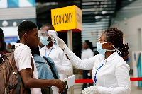 Medical staff check the temperature of people