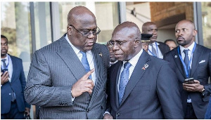 DR Congo President Felix Tshisekedi (left) talks with Angola's Foreign Minister Tete Antonio