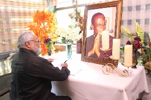 Former President, Jerry John Rawlings signing the book of condolence