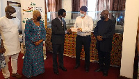 The investor (second right) presents a cheque to Prof Apostle Onyinah