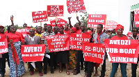 A picture of the aggrieved delegates holding placards