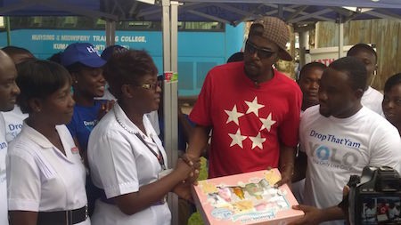 Head of Marketing for tigo Ghana Jesse Agyepong with Kwaw Kesse donating items to KATH