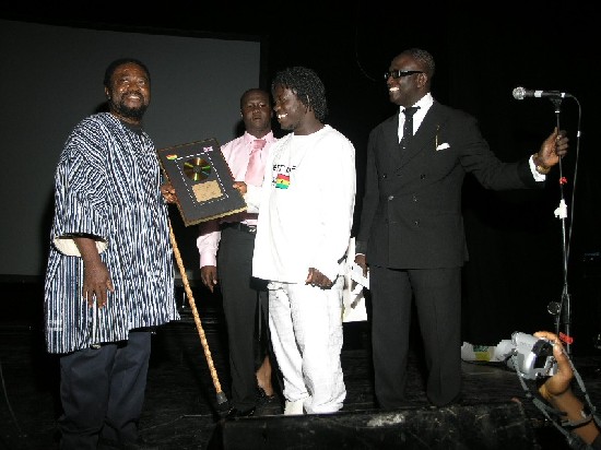 Obour receives his Song of the Year award from Teddy Osei of Osibisa